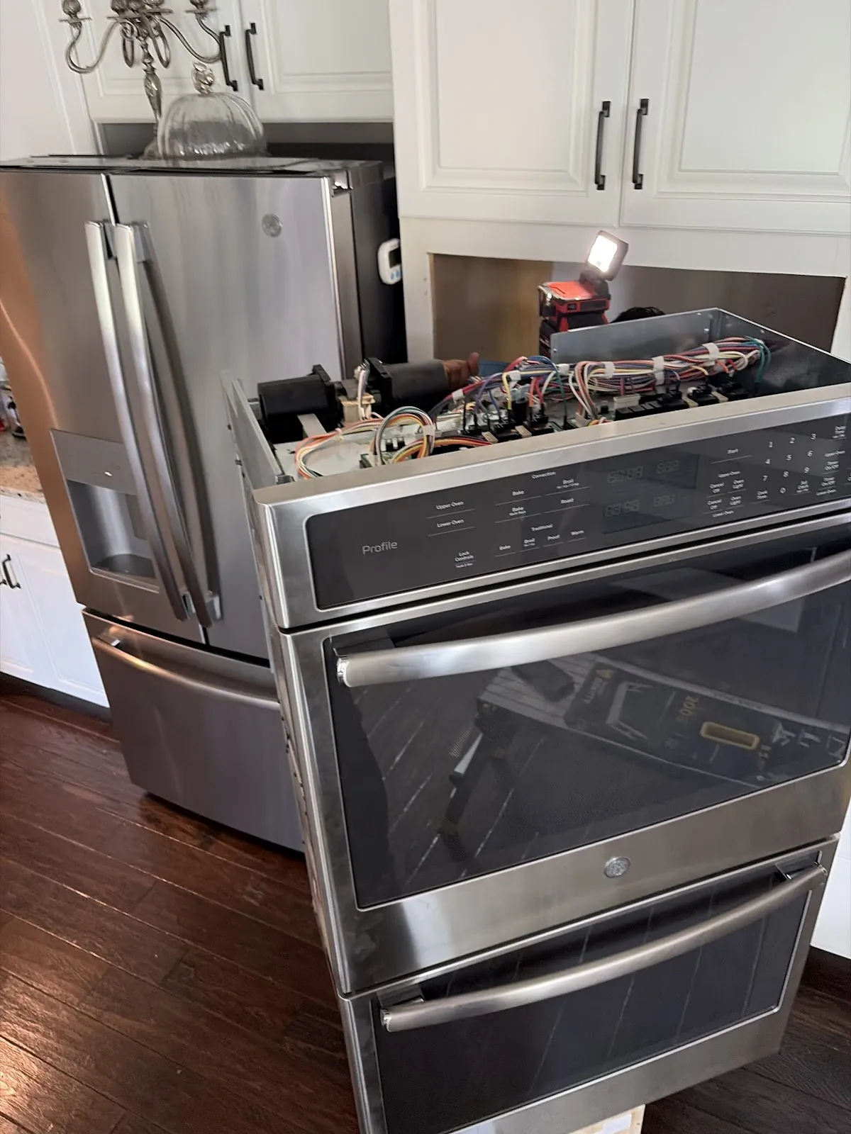 Double wall oven with the control panel removed for diagnosis