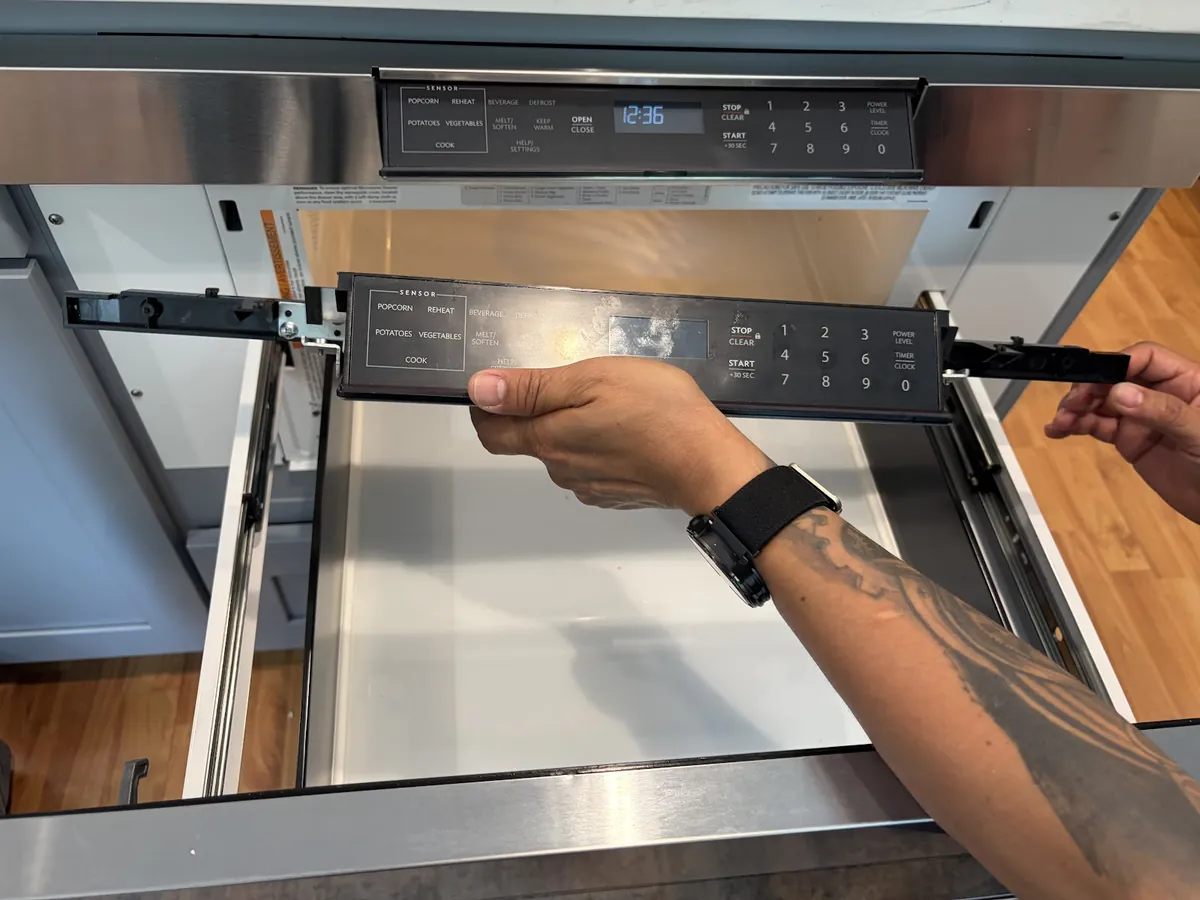 Built-in microwave drawer being removed for service